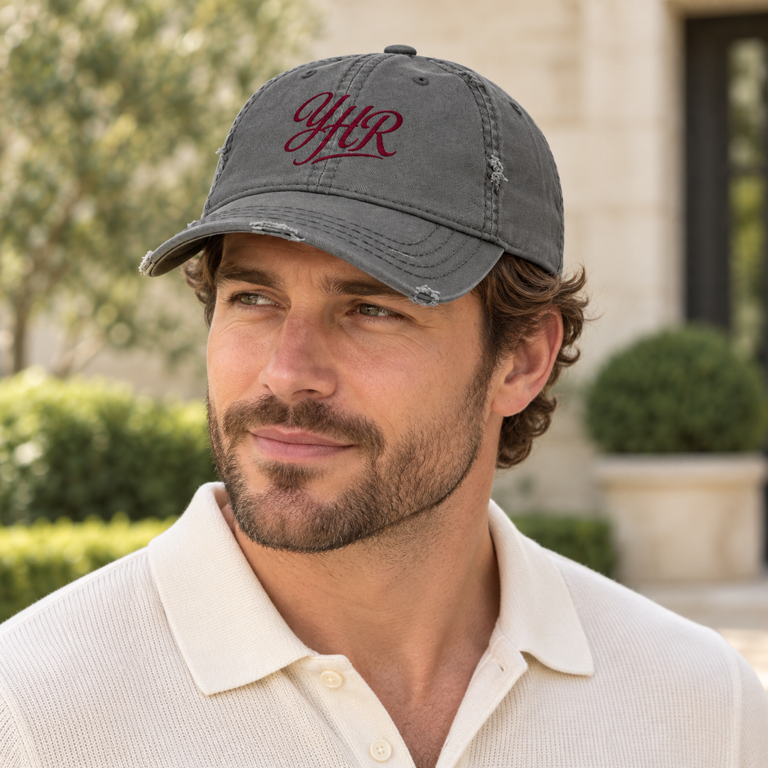 AI-generated lifestyle styling image of YHR Script Distressed Dad Hat – Charcoal/Khaki.
