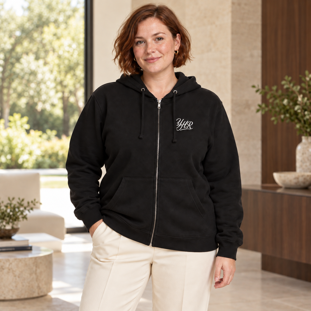 AI-generated lifestyle styling image of YHR Script Fleece Zip-Up Hoodie in an upscale setting.