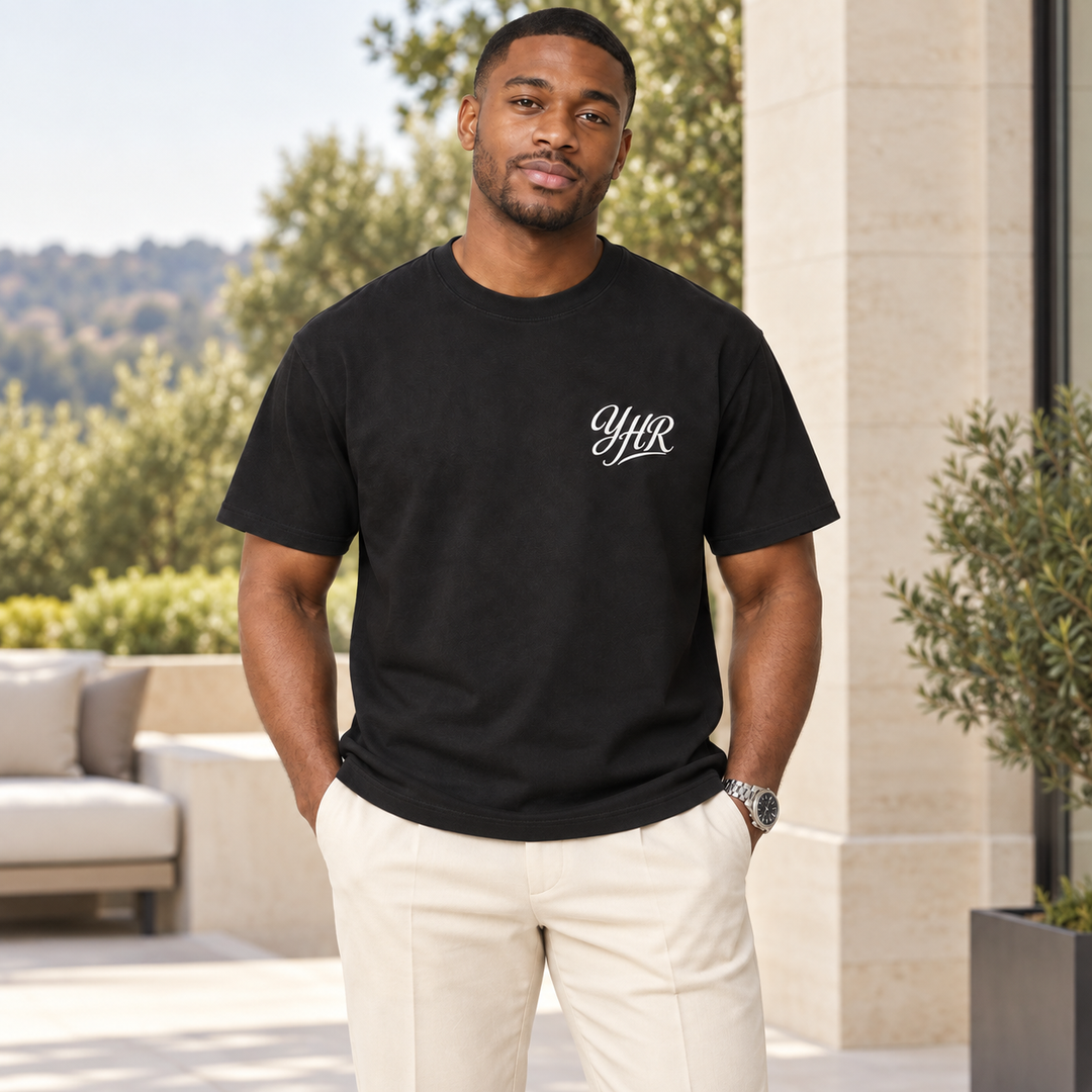 AI-generated lifestyle styling image of YHR Script Garment-Dyed Heavyweight T-Shirt – Dark in an upscale setting.