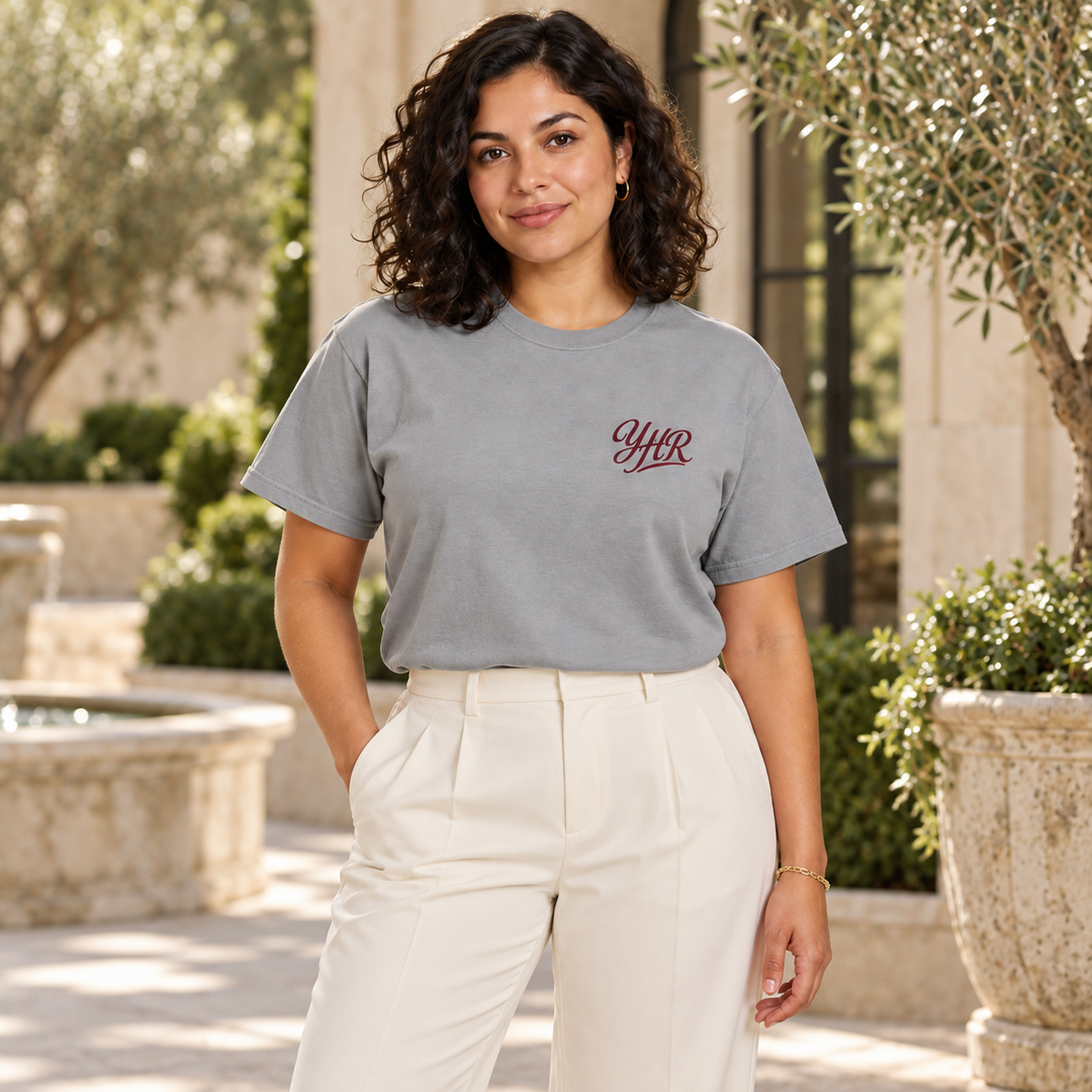 AI-generated lifestyle styling image of YHR Script Garment-Dyed Heavyweight T-Shirt – Light in an upscale setting.