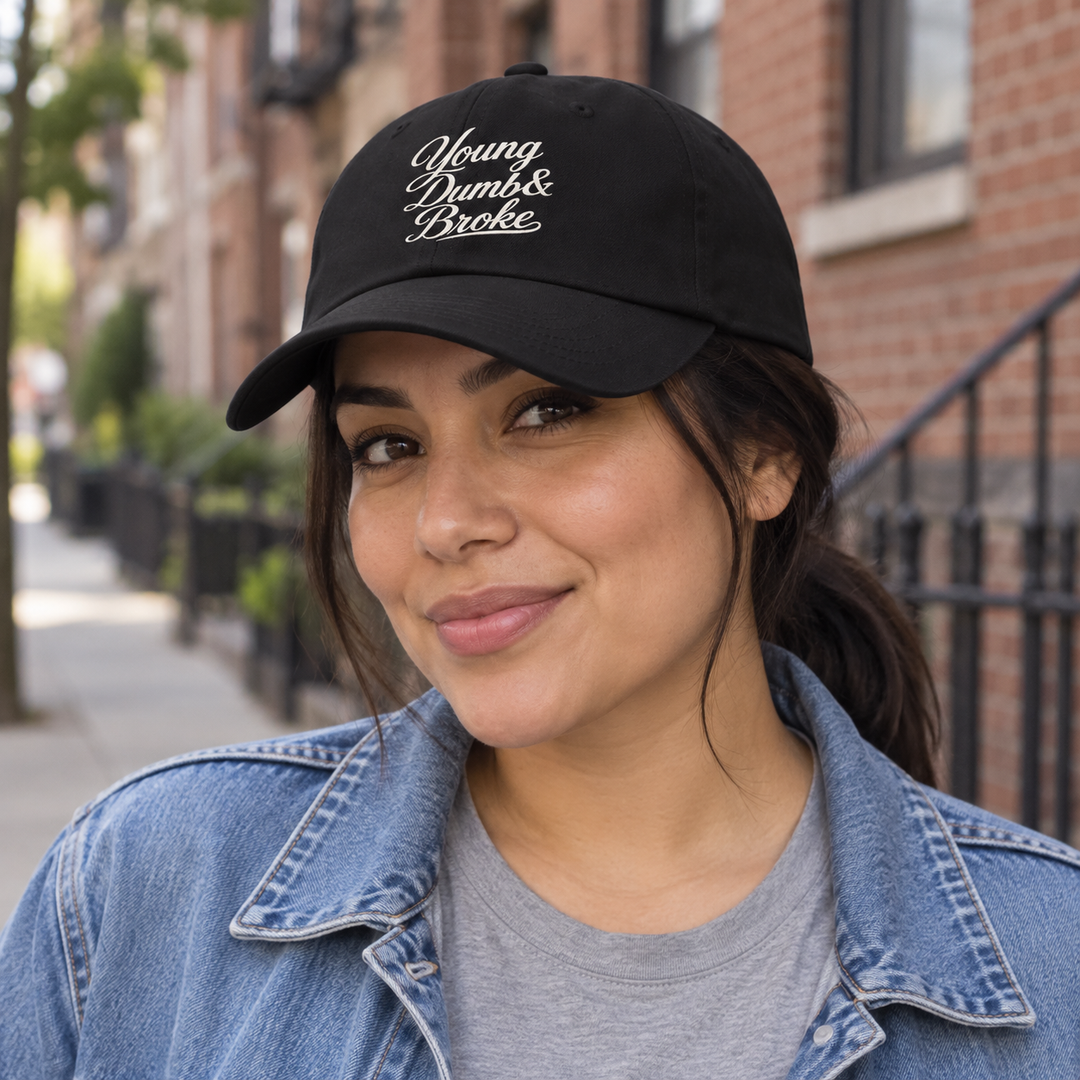 AI-generated lifestyle styling image of Young Dumb & Broke Classic Dad Hat – Dark.