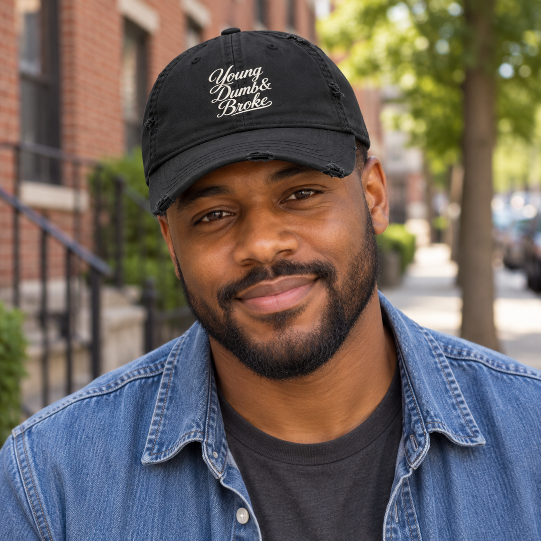 AI-generated lifestyle styling image of Young Dumb & Broke Distressed Dad Hat – Black/Navy.
