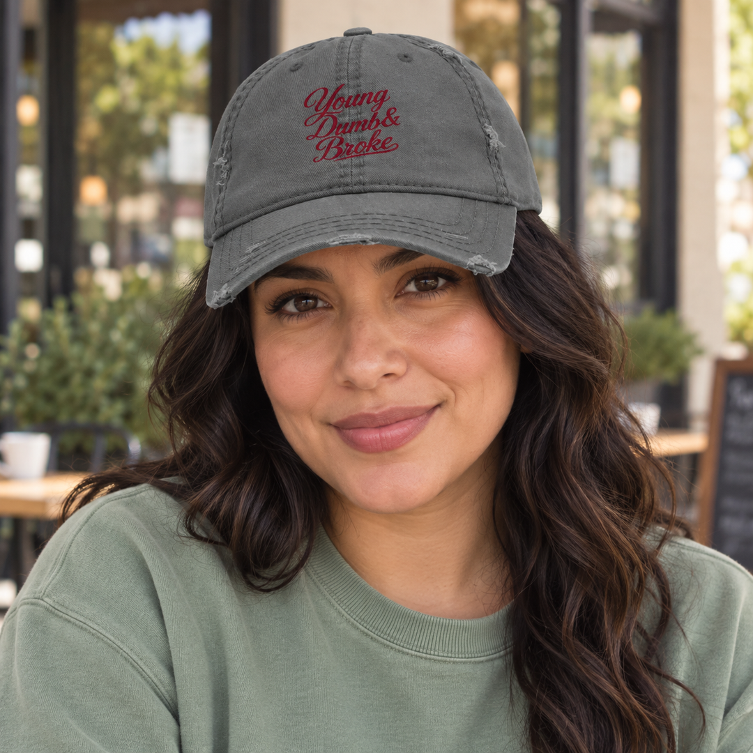 AI-generated lifestyle styling image of Young Dumb & Broke Distressed Dad Hat – Charcoal/Khaki.
