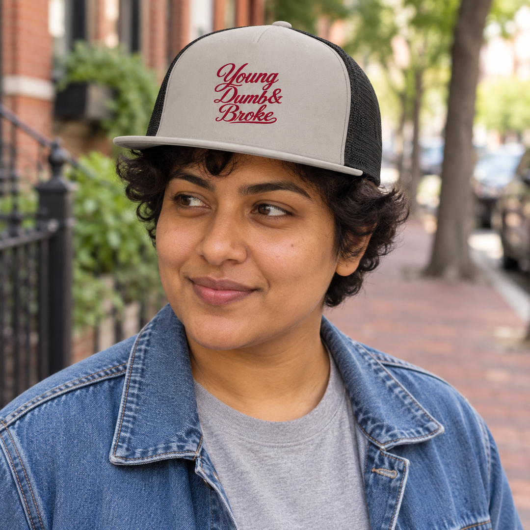 AI-generated lifestyle styling image of Young Dumb & Broke Five-Panel Trucker Cap.