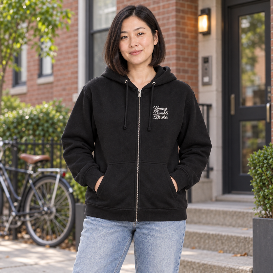 AI-generated lifestyle styling image of Young Dumb & Broke Fleece Zip-Up Hoodie in an everyday neighborhood setting.