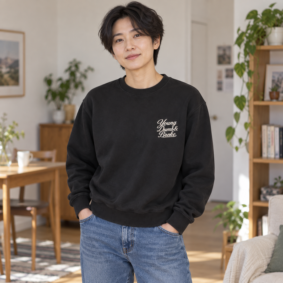 AI-generated lifestyle styling image of Young Dumb & Broke Garment-Dyed Fleece Crewneck – Dark.