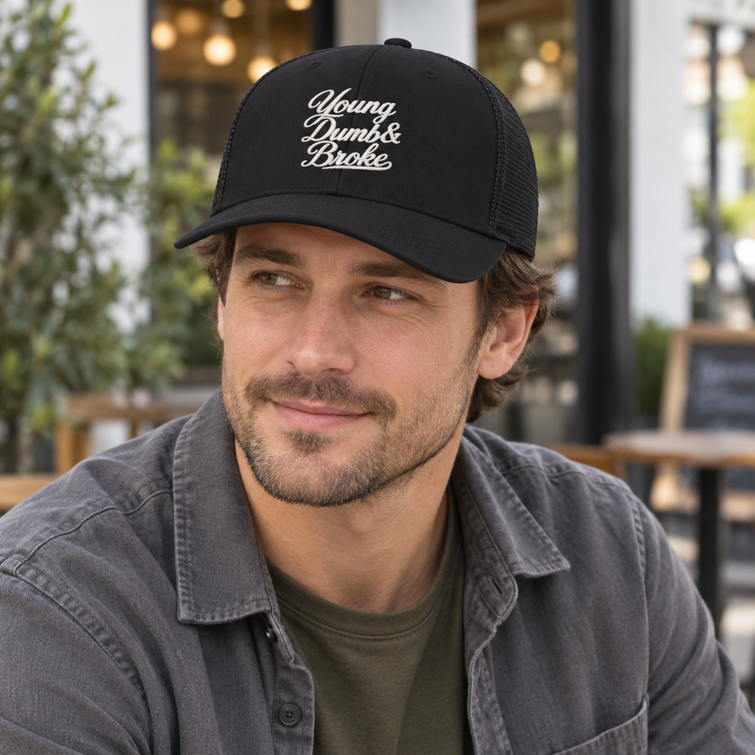 AI-generated lifestyle styling image of Young Dumb & Broke Retro Trucker Cap.