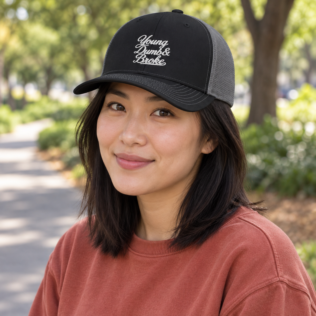 AI-generated lifestyle styling image of Young Dumb & Broke Snapback Trucker Cap.